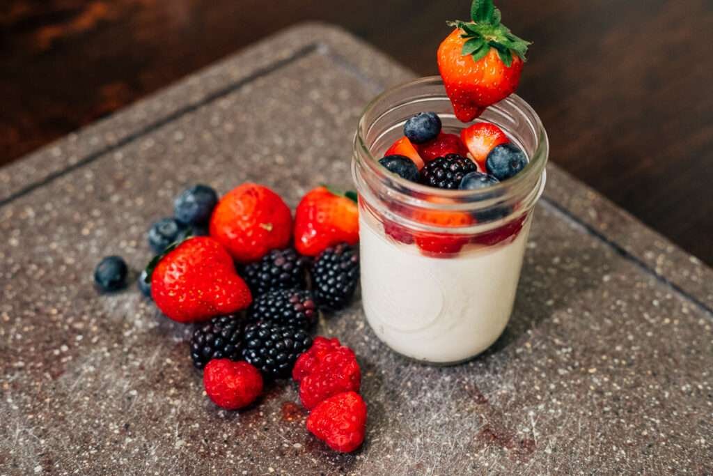 russian creme with berries on a cutting board, simply sid & co