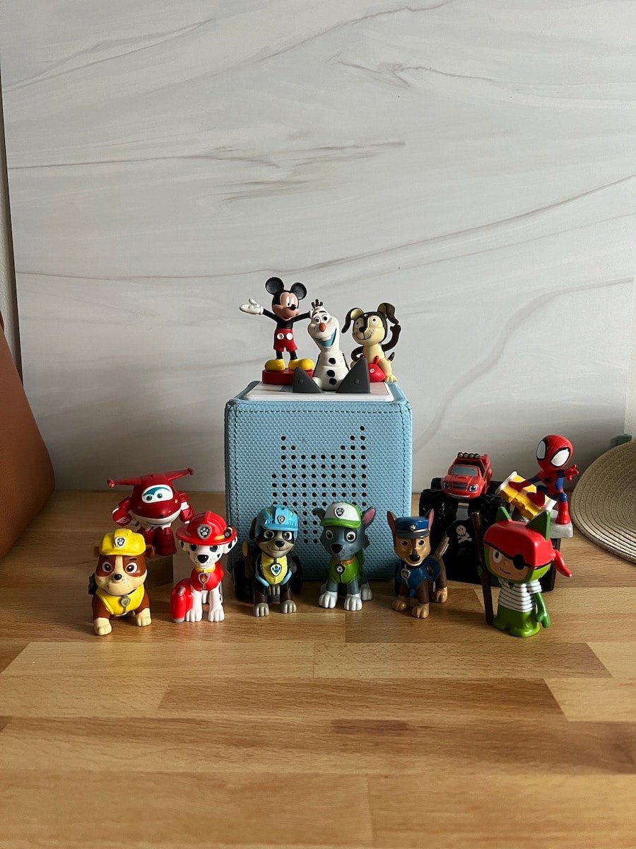 Tonie box with several different tonies that can be used as toddler toys for road trips.